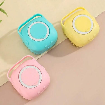 Three small square handheld scrubber or brush devices in pastel pink, light blue, and pale yellow, arranged on a soft beige background.